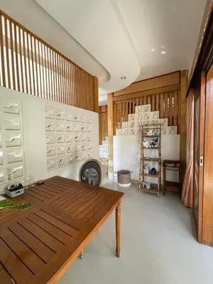 a dining room with a wooden table in a room at Karmani Villa Managed by Alyssa Villa Management in Ujung
