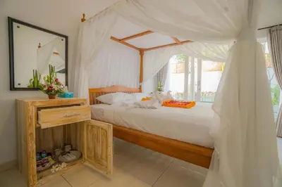 a bedroom with a bed with a canopy at Deluxe room near seminyak beach in Seminyak