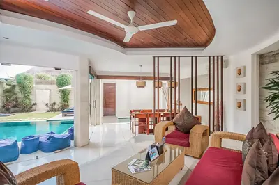 a living room with a ceiling fan and a pool at Villa K Seminyak by Premier Hospitality Asia in Seminyak