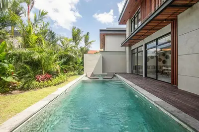 a swimming pool in the backyard of a house at Stunning 5BR Canggu Villa 400m from the Beach in Canggu