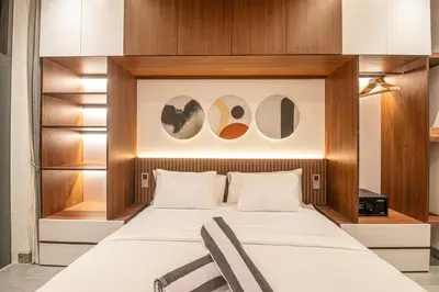 a bedroom with a bed with a wooden headboard at Stunning 5BR Canggu Villa 400m from the Beach in Canggu