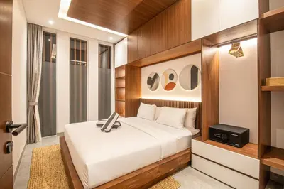 a bedroom with a bed and a television in it at Luxury 5-Bedroom Oasis 400 m to Canggu Sand in Canggu