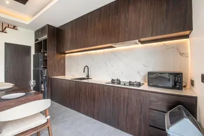 a kitchen with a sink and a microwave at Luxury 5-Bedroom Oasis 400 m to Canggu Sand in Canggu
