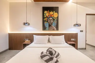a bedroom with a bed with a painting on the wall at Serene 5-Bedroom Villa 400 m from Batu Bolong in Canggu