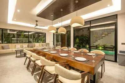 a large dining room with a long table and chairs at Serene 5-Bedroom Villa 400 m from Batu Bolong in Canggu