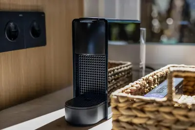 a black appliance sitting on a table next to a basket at Contemporary 2BR Luxury Villa with Rooftop View and Pool in Kerobokan