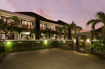 a building with a courtyard in front of it at Srikandi Inn in Jimbaran