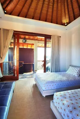 a bedroom with two beds and a balcony at Bob's Hideaway Villa - Umalas in Umalas