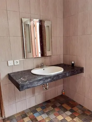 a bathroom with a sink and a mirror at Bob's Hideaway Villa - Umalas in Umalas