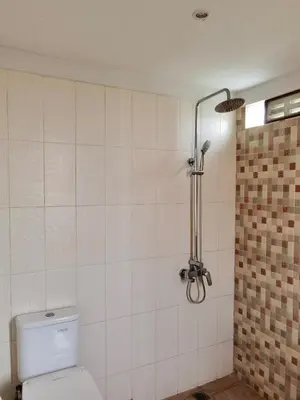 a bathroom with a toilet and a shower at Bob's Hideaway Villa - Umalas in Umalas