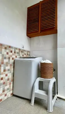 a white refrigerator in a kitchen with a stool at Bob's Hideaway Villa - Umalas in Umalas