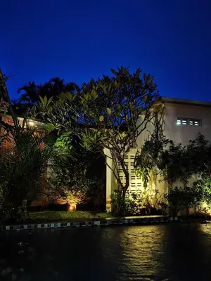 a house at night with a tree in the foreground at Bob's Hideaway Villa - Umalas in Umalas