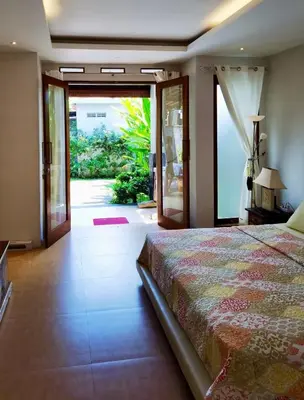 a bedroom with a bed and a sliding glass door at Bob's Hideaway Villa - Umalas in Umalas