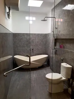 a bathroom with a tub and a toilet and a shower at Chic Villa at Kubu Taullan 3B in Kerobokan