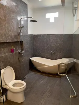 a bathroom with a tub and a toilet and a sink at Chic Villa at Kubu Taullan 3B in Kerobokan