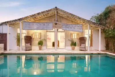 a house with a pool in front of it at Villa Bohème Umalas in Canggu