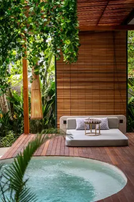 a pool in a backyard with a bed and a table at Kayunida - Charming 1BR Wooden Villa in Seminyak in Seminyak