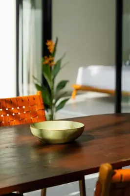 a bowl sitting on top of a wooden table at Rooftop Villa Elegant 4BR Retreat in Umalas in Kerobokan