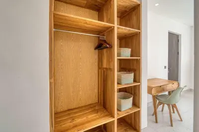 a wooden book shelf in a room with a desk at Rooftop Villa Elegant 4BR Retreat in Umalas in Kerobokan