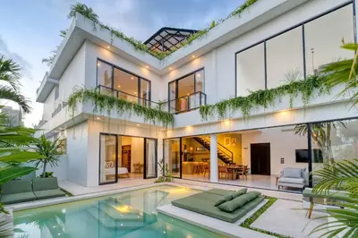 a house with a swimming pool in front of it at Rooftop Villa Elegant 4BR Retreat in Umalas in Kerobokan