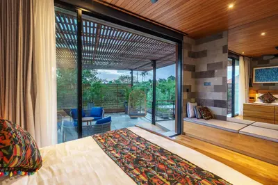 a bedroom with a bed and a large window at Luxury Resort of 4 villas 11 BR Seminyak in Seminyak
