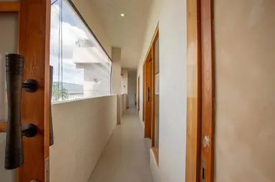 a hallway of a hospital with a window and a long corridor at Casa Ombak in Kerobokan