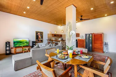 a living room with a table and a couch at Villa Anvira in Seminyak