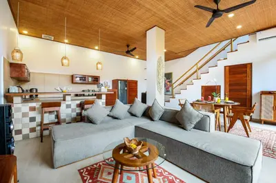 a living room with a couch and a table at Villa Anvira in Seminyak