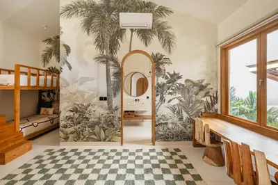 a room with palm trees mural on the wall at Villa Nusa in Canggu