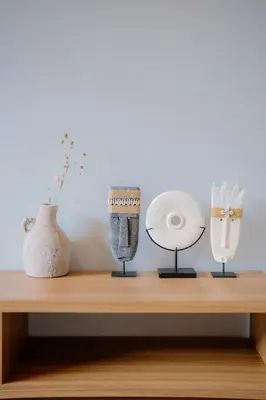 a shelf with three vases and other items on it at Arjuna Villa in Seminyak