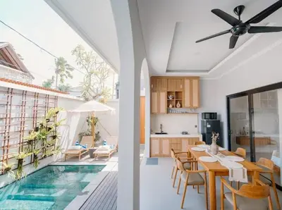 a kitchen and a living room with a swimming pool at Arjuna Villa in Seminyak