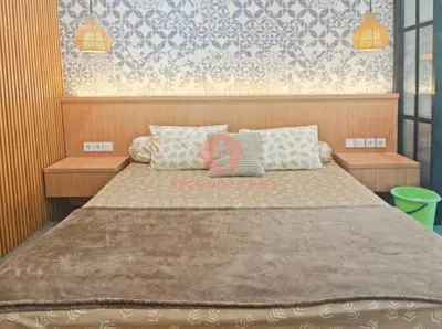 a bedroom with a large bed with pillows on it at Lavaya Resort 1BR Nusa Dua Pool, WiFi, Netflix in Nusa Dua