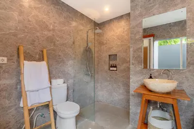 a bathroom with a toilet and a sink and a shower at Casa Amore Villa in Berawa Beach - Canggu in Canggu