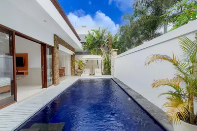 an infinity pool in the backyard of a villa at Casa Amore Villa in Berawa Beach - Canggu in Canggu
