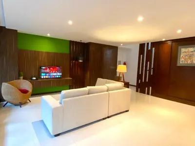 a living room with a white couch and a tv at Bloomingville Villas in Nusa Dua in Nusa Dua