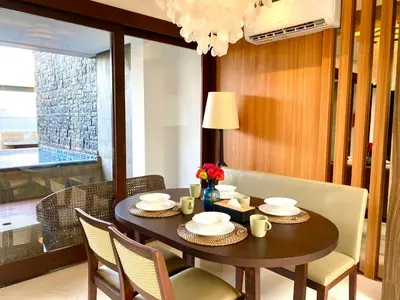 a dining room with a table with chairs and a tableablish at Bloomingville Villas in Nusa Dua in Nusa Dua