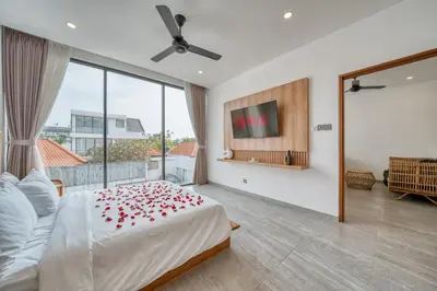 a bedroom with a bed with red roses on it at Tropical and Minimalist 2bd Umalas Villa with Private Pool in Canggu
