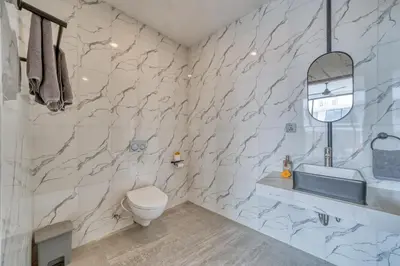 a bathroom with a toilet and a sink at Tropical and Minimalist 2bd Umalas Villa with Private Pool in Canggu