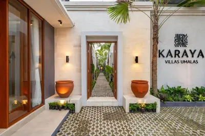 a door to a building with two large vases at Karaya Villas Umalas - Free In-Villa Culture Immersion Programs in Kerobokan