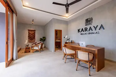 a room with a desk and chairs in a room at Karaya Villas Umalas - Free In-Villa Culture Immersion Programs in Kerobokan