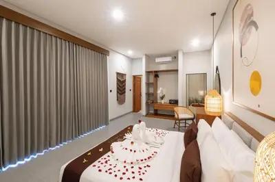 a hotel room with a bed and a couch at Karaya Villas Umalas - Free In-Villa Culture Immersion Programs in Kerobokan