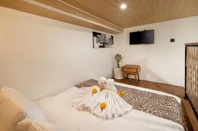 a bedroom with a bed with a dress on it at Cozia Living in Jimbaran