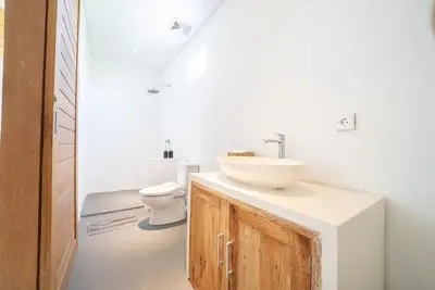 a bathroom with a sink and a toilet at Villa Amie Elegant 5BR with Pool & Rooftop Umalas in Canggu