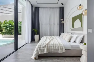 a bedroom with a bed and a pool at Brand New Luxury Design Villa by Amare Villas 4 in Badung