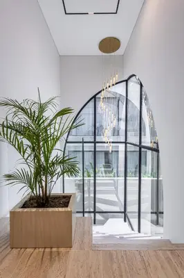a potted plant in a room with a large window at Brand New Luxury Design Villa by Amare Villas 4 in Badung