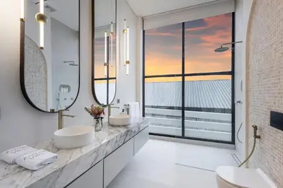 a bathroom with two sinks and a large window at Brand New Luxury Design Villa by Amare Villas 2 in Badung