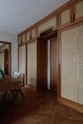 a living room with wooden doors and a table at Lavanya Villa Berawa beach in Canggu