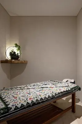 a bed with a quilt on it in a room at Lavanya Villa Berawa beach in Canggu