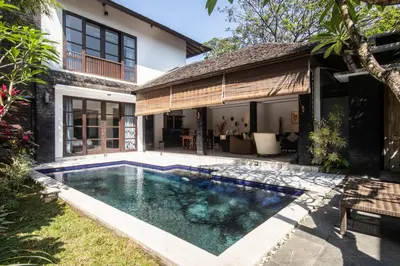 a swimming pool in the backyard of a house at Vase 2BR Villa Seminyak in Seminyak