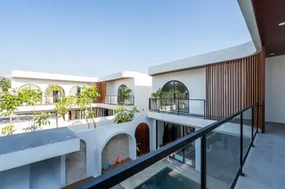 an external view of a building with a swimming pool at La Vilaya Villa in Kerobokan